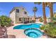 Backyard with a pool, jacuzzi, patio, and palm trees creating a relaxing outdoor oasis at 8942 Galena Crossing St, Las Vegas, NV 89123