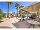 Spacious backyard with a pool, shaded seating, mature landscaping, and a serene atmosphere at 8942 Galena Crossing St, Las Vegas, NV 89123