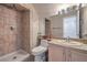 Bathroom featuring a tiled shower, modern fixtures, and a vanity with sink at 8942 Galena Crossing St, Las Vegas, NV 89123