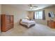 Spacious bedroom with carpet, a ceiling fan, a window, and an entertainment center at 8942 Galena Crossing St, Las Vegas, NV 89123