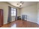 Bedroom with hardwood floors, a ceiling fan, a window, and closet space at 8942 Galena Crossing St, Las Vegas, NV 89123