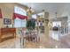 Bright dining area with tile floors, neutral walls, large windows, and an elegant chandelier at 8942 Galena Crossing St, Las Vegas, NV 89123