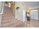 Inviting entryway featuring a staircase and tile flooring, leading to the upper level at 8942 Galena Crossing St, Las Vegas, NV 89123