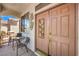 Inviting front entrance with a stylish door, decorative accents, and cozy seating area at 8942 Galena Crossing St, Las Vegas, NV 89123