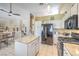 Bright kitchen featuring white cabinets and a black refrigerator with an island at 8942 Galena Crossing St, Las Vegas, NV 89123