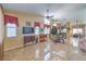 Open-concept living room with tiled floors, a ceiling fan, neutral walls, and views into the dining area at 8942 Galena Crossing St, Las Vegas, NV 89123