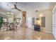 Spacious living room featuring tiled floors, a ceiling fan, a staircase, and neutral-colored walls at 8942 Galena Crossing St, Las Vegas, NV 89123