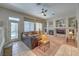 Cozy living room featuring a fireplace, comfortable seating, and a view of the backyard at 8942 Galena Crossing St, Las Vegas, NV 89123