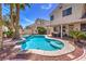 Sparkling pool with inviting step-down entry surrounded by lush landscaping in a private backyard oasis at 8942 Galena Crossing St, Las Vegas, NV 89123