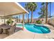 Beautiful pool with a spa, surrounded by palm trees and a covered patio with ample seating space at 8942 Galena Crossing St, Las Vegas, NV 89123