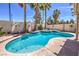 Gorgeous backyard pool featuring a unique design and surrounding landscaping at 8942 Galena Crossing St, Las Vegas, NV 89123