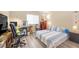 Functional bedroom featuring a built-in desk, comfortable seating, and soft natural light, ideal for work, study, and relaxation at 9981 Sable Point St, Las Vegas, NV 89178