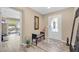 Warm foyer with hardwood floors, a stylish bench, and views of the backyard at 9981 Sable Point St, Las Vegas, NV 89178