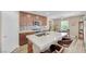 Bright kitchen featuring a central island with countertop seating, modern appliances, and ample natural light, ideal for everyday meals at 9981 Sable Point St, Las Vegas, NV 89178