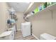 Functional laundry room with washer, dryer, shelving, and practical storage solutions at 9981 Sable Point St, Las Vegas, NV 89178