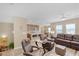 Open-concept living room showcasing hardwood floors, modern furnishings, and seamless flow to the kitchen at 9981 Sable Point St, Las Vegas, NV 89178
