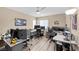 Spacious office space with light wood floors, multiple monitors, and a ceiling fan at 9981 Sable Point St, Las Vegas, NV 89178