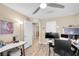 Bright home office with light wood floors and large posters on the walls at 9981 Sable Point St, Las Vegas, NV 89178