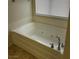Relaxing bathtub with jacuzzi jets and a neutral color at 1003 Dover Glen Dr, North Las Vegas, NV 89031