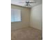 A cozy bedroom with a ceiling fan and a window that offers natural light at 1003 Dover Glen Dr, North Las Vegas, NV 89031