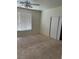 A bright bedroom featuring a ceiling fan, neutral carpet, and a window at 1003 Dover Glen Dr, North Las Vegas, NV 89031