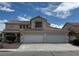 Two-story home featuring a three-car garage and a terracotta-tile roof at 1003 Dover Glen Dr, North Las Vegas, NV 89031