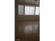 Bright living room featuring tile floors, a ceiling fan, and large windows at 1003 Dover Glen Dr, North Las Vegas, NV 89031