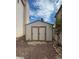 View of backyard shed, nestled on rock landscape, with double doors at 1003 Dover Glen Dr, North Las Vegas, NV 89031