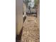 Narrow view of the side yard showing a walkway to backyard at 1003 Dover Glen Dr, North Las Vegas, NV 89031