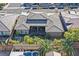 Aerial view of a home featuring a covered patio and a backyard oasis with a lawn, garden, and a swimming pool at 10150 Emerald Sunset Ct, Las Vegas, NV 89148