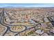 Wide aerial shot showcases a community with landscaped roundabouts and orderly housing layouts at 10150 Emerald Sunset Ct, Las Vegas, NV 89148