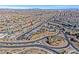 Expansive aerial view of a residential neighborhood featuring curved streets and desert landscaping at 10150 Emerald Sunset Ct, Las Vegas, NV 89148