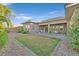 Expansive backyard with a green lawn, patio, and landscaped areas, perfect for outdoor activities and relaxation at 10150 Emerald Sunset Ct, Las Vegas, NV 89148