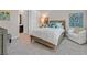 Comfortable bedroom with a queen bed, soft lighting, and an en-suite bathroom at 10150 Emerald Sunset Ct, Las Vegas, NV 89148