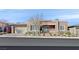 Contemporary home with a well-manicured front yard, two-car garage, and stone accents on the exterior at 10150 Emerald Sunset Ct, Las Vegas, NV 89148