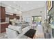 Open-concept living room and kitchen with high ceilings, modern lighting, and large windows at 10150 Emerald Sunset Ct, Las Vegas, NV 89148