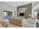 Bright living room featuring high ceilings, a decorative accent wall, and sliding glass doors at 10150 Emerald Sunset Ct, Las Vegas, NV 89148