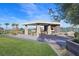 An outdoor kitchen area with covered dining is perfect for entertaining, with grassy lawn nearby at 10150 Emerald Sunset Ct, Las Vegas, NV 89148
