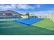 Bright blue and green tennis courts with shaded benches offer a fun recreational activity for residents at 10150 Emerald Sunset Ct, Las Vegas, NV 89148
