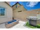 Beautiful backyard featuring a blue-glass fire pit and barbecue at 10172 Fire Skye Ave, Las Vegas, NV 89166