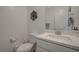 Clean half bath features a white vanity with decorative flower art and sink at 10172 Fire Skye Ave, Las Vegas, NV 89166
