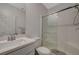 Bright bathroom featuring a modern vanity, shower with glass door, and neutral color scheme at 10172 Fire Skye Ave, Las Vegas, NV 89166