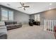 Spacious bonus room featuring carpet floors, gray walls, a ceiling fan, and bright light from two windows at 10172 Fire Skye Ave, Las Vegas, NV 89166