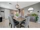 Bright dining room featuring a modern chandelier, stylish decor, and a staircase nearby at 10172 Fire Skye Ave, Las Vegas, NV 89166