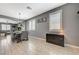 Elegant dining room featuring modern lighting, wood-look tile flooring, and plantation shutters for a contemporary look at 10172 Fire Skye Ave, Las Vegas, NV 89166