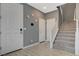 Welcoming foyer features a staircase and multiple access doors with stylish neutral tones at 10172 Fire Skye Ave, Las Vegas, NV 89166