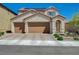 Charming two-story home featuring a spacious three-car garage and desert landscaping for excellent curb appeal at 10172 Fire Skye Ave, Las Vegas, NV 89166