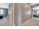 Hallway with gray walls and plush carpeting, leading to a bedroom and living room at 10172 Fire Skye Ave, Las Vegas, NV 89166