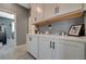 Hallway with cabinetry and countertops leading to a bedroom with plush carpet at 10172 Fire Skye Ave, Las Vegas, NV 89166