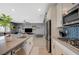 Spacious kitchen with modern appliances and a large island opens to the living room at 10172 Fire Skye Ave, Las Vegas, NV 89166